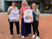 Cafe-Vielfalt-Drei Frauen halten Schild hoch